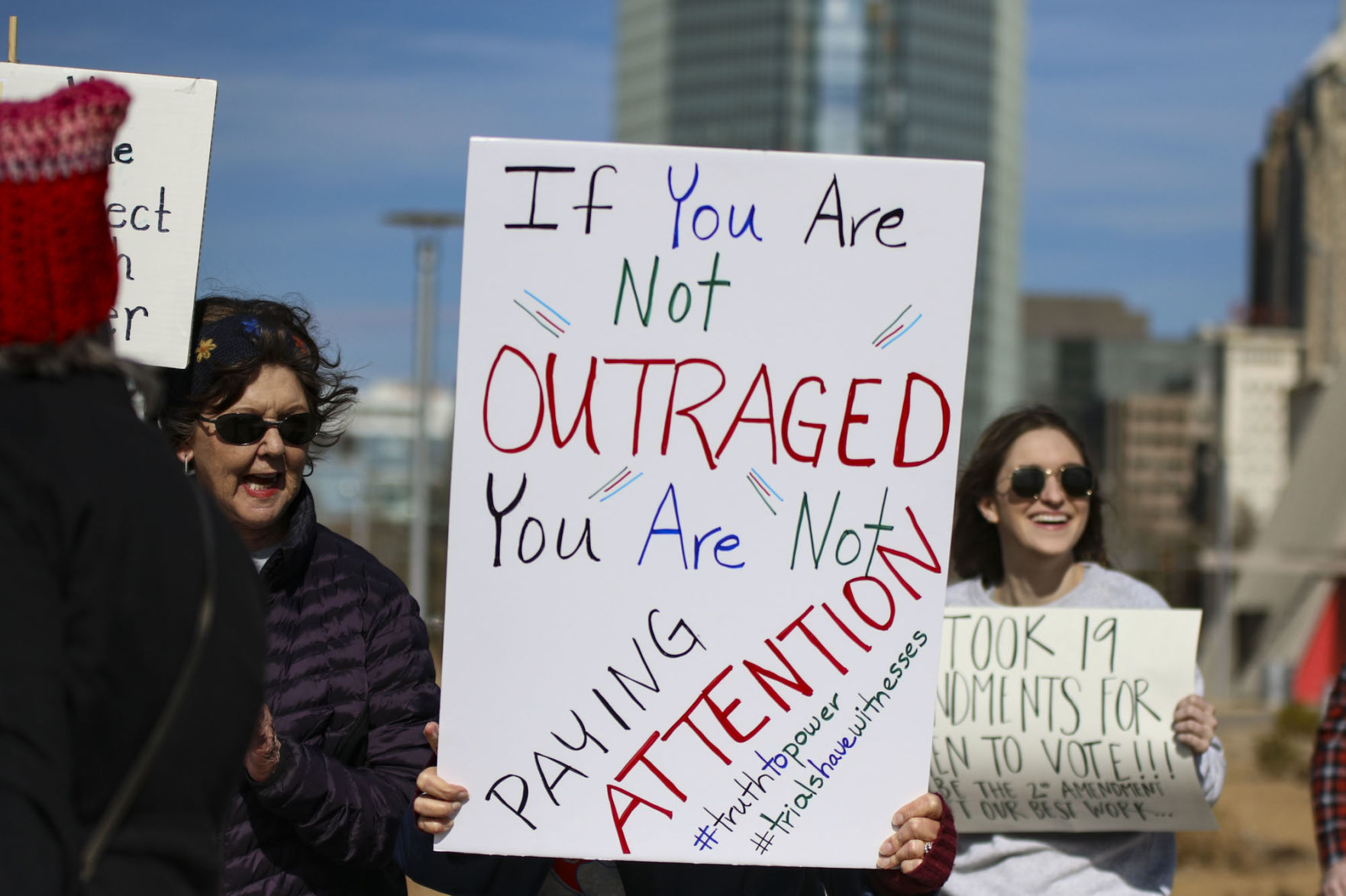 “If you are not outraged you are not paying attention” sign